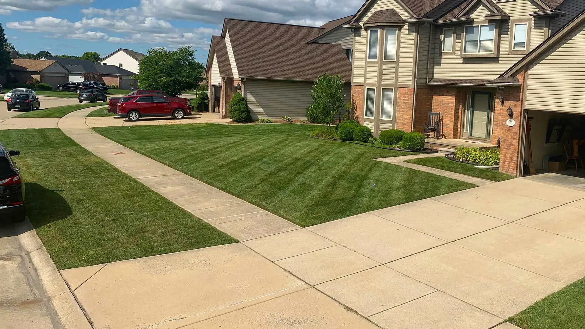 A Shelby, MI home with mowing lines in the front yard.