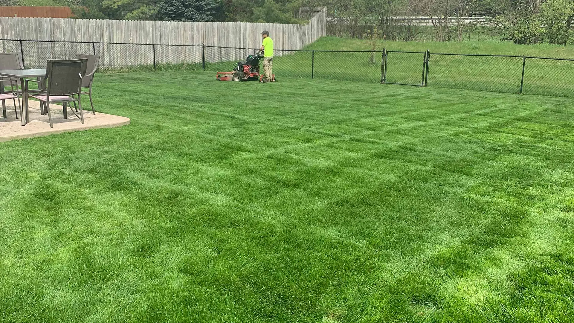 A Chesterfield, MI home lawn being mowed after a spring yard cleanup.