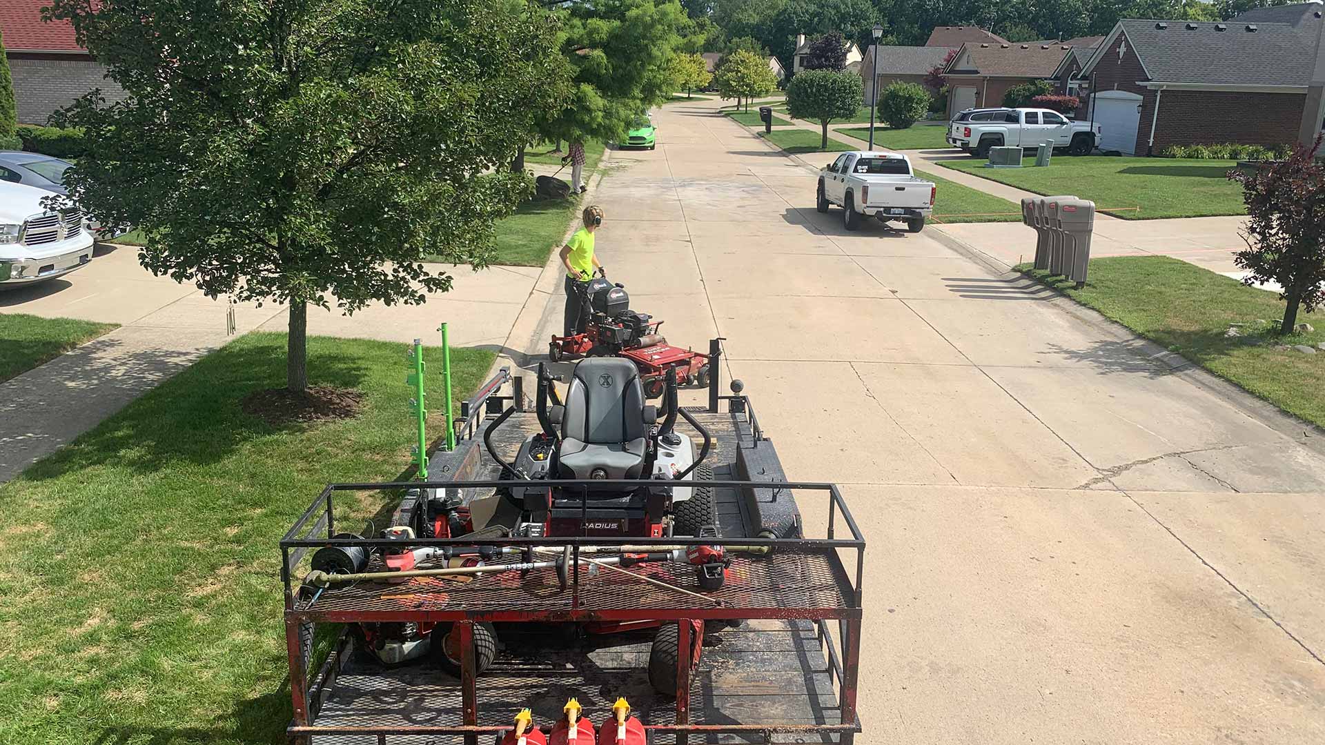 Big Lakes Lawncare worker and mower in Macomb Co, MI.