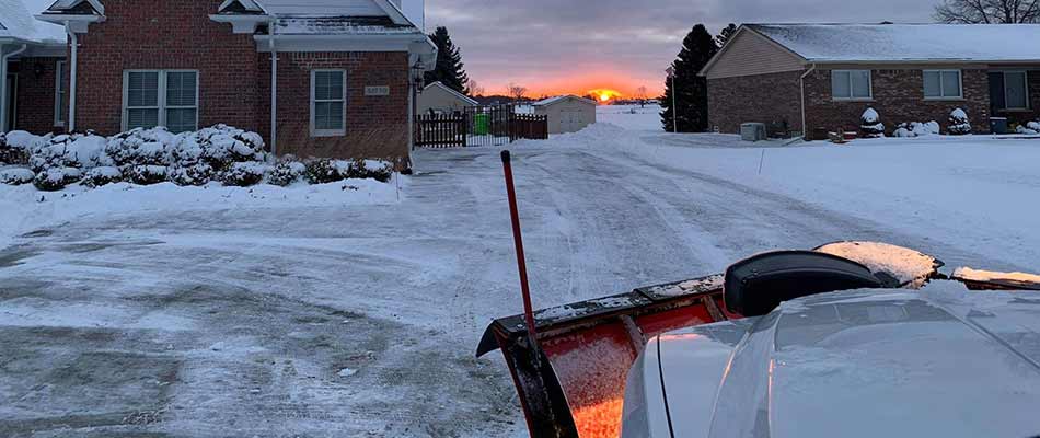 Snow removal services at sunset near Chesterfield, MI.