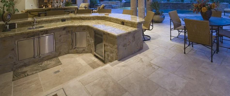 An outdoor kitchen in Macomb, MI, with a sink, steps, and a table.