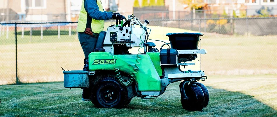 Man on fertilizer spreader machine in Macomb, MI.