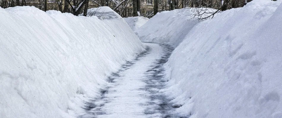 Tall pile of snow along a walkway in Macomb, MI.
