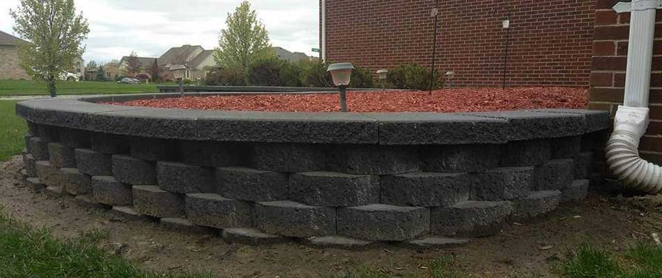 Raised landscape bed with red mulch in Shelby, MI.