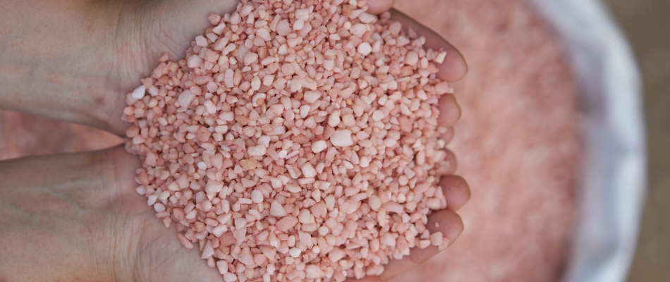 Handful of potassium pellets for fertilizer treatment in Washington, MI.