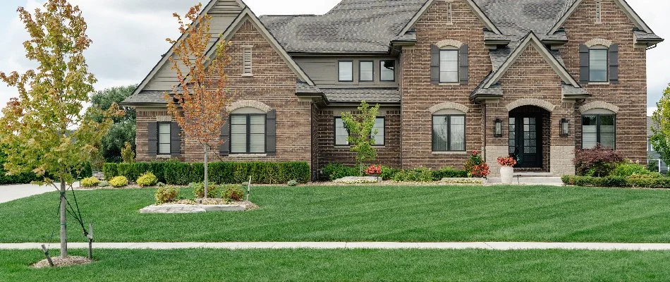 Lush, green lawn and plants with a house in Hazel Park, MI.