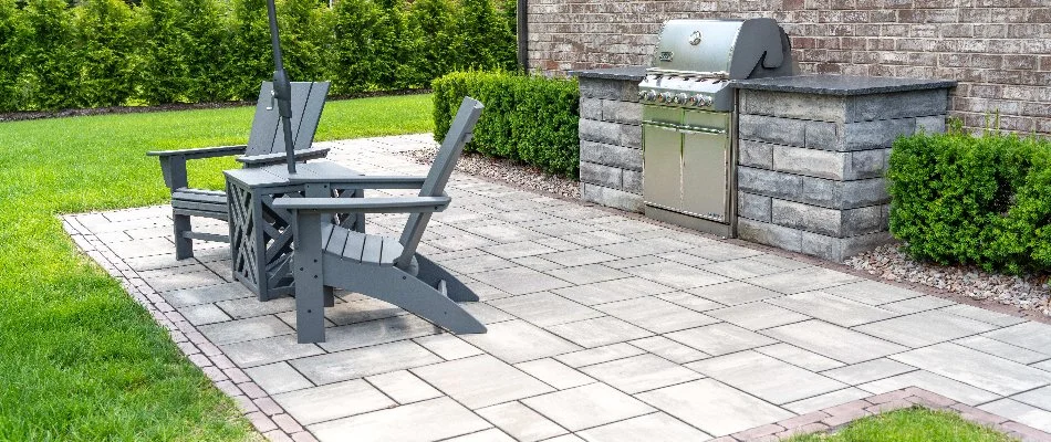 Patio with chairs and built-in grill near Chesterfield, MI.