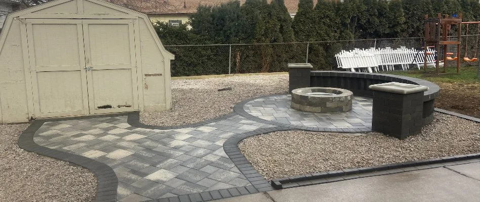 Outdoor space with patio, fire pit, and seating wall in Birmingham, MI.